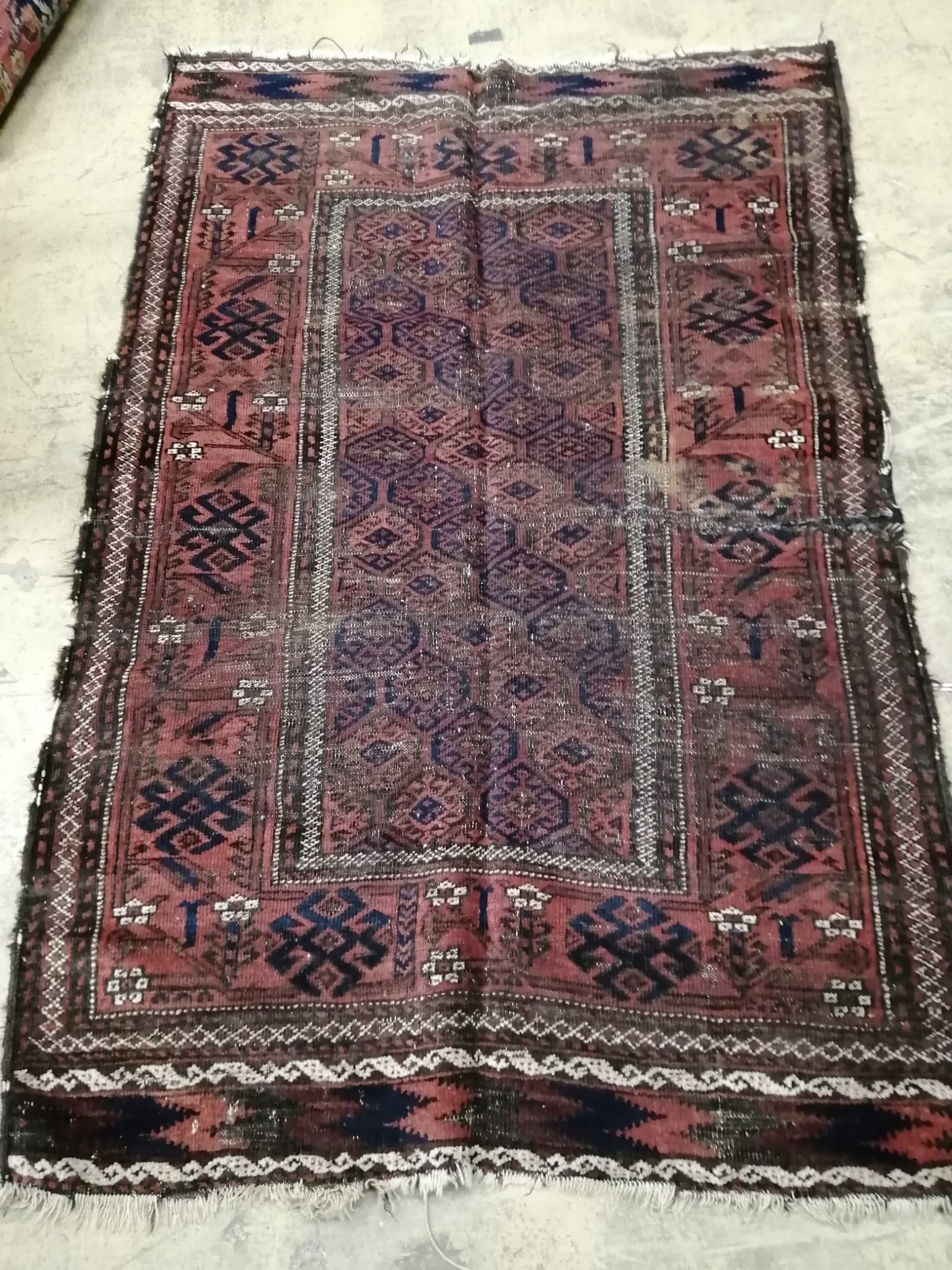 An antique Belouch red rug, 140 x 100cm